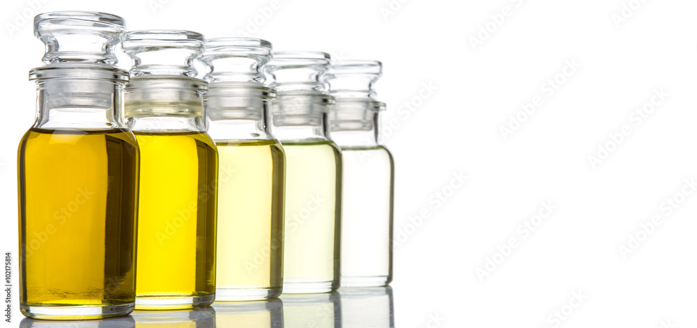 Avocado fruit oil, sesame seed oil, olive oil, grape seed oil and corn oil in vial glass bottle over white background