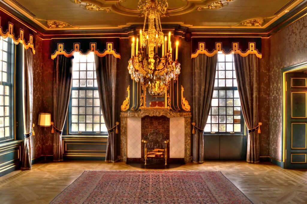 Opulent palace living room featuring a grand golden chandelier and elaborate interior design.