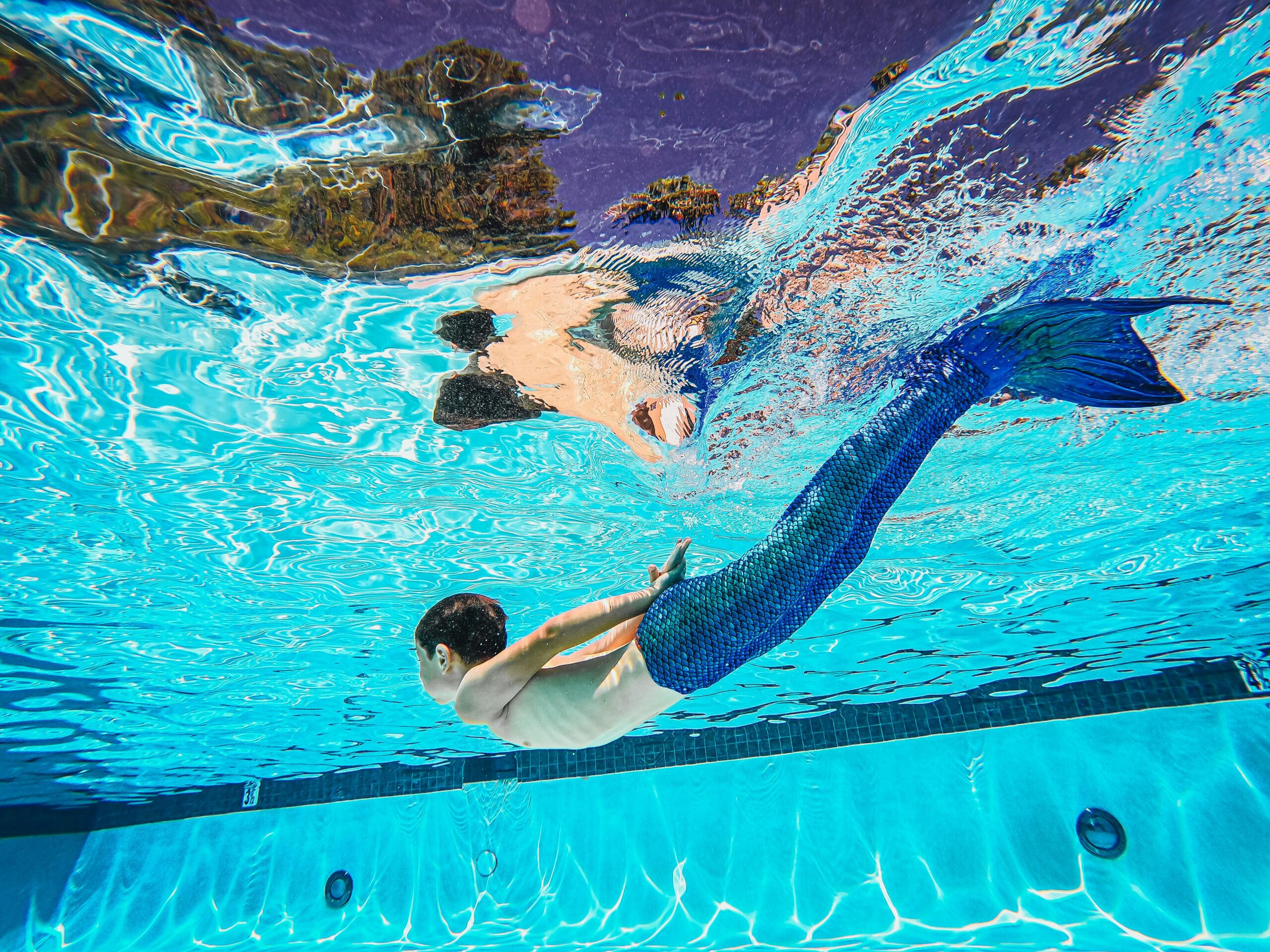 Person wearing a mermaid suit swimming