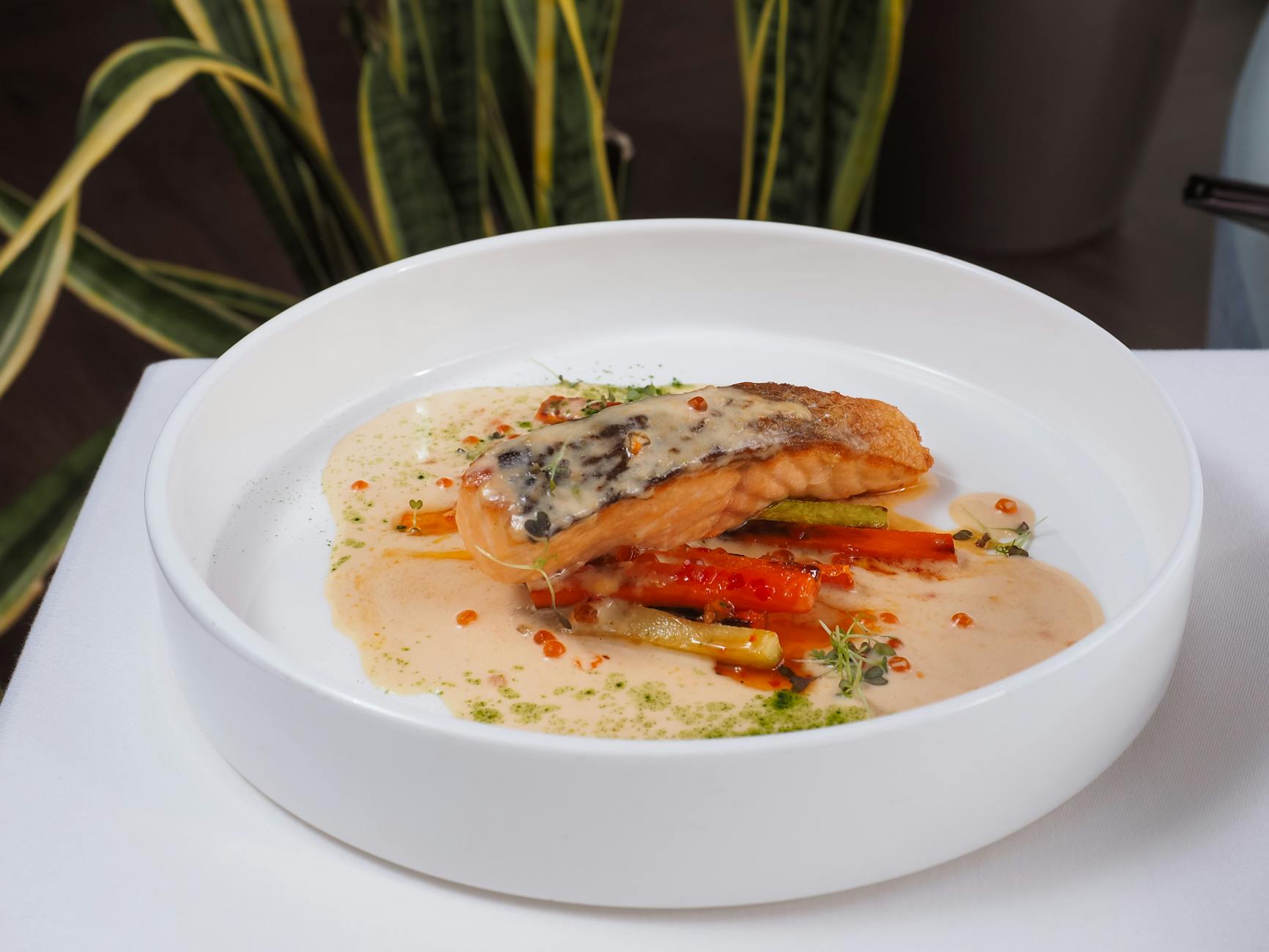 photograph of a cuisine with fish and sauce