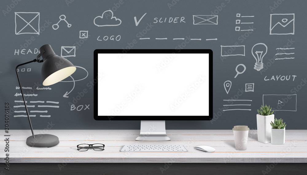 Web design studio computer display mockup. Display surrounded by web site sketched parts.