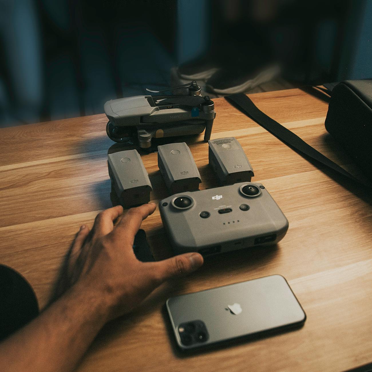 drone parts and camera over a wooden table