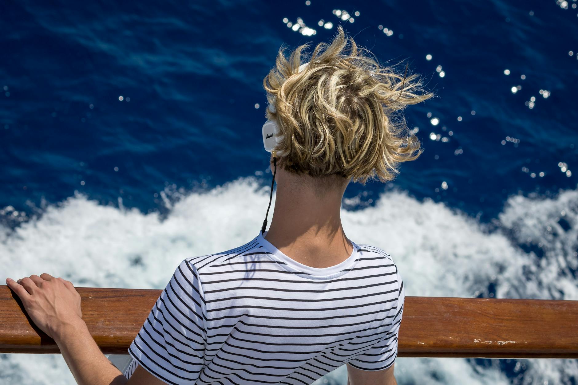 close up photography of man looking down the sea