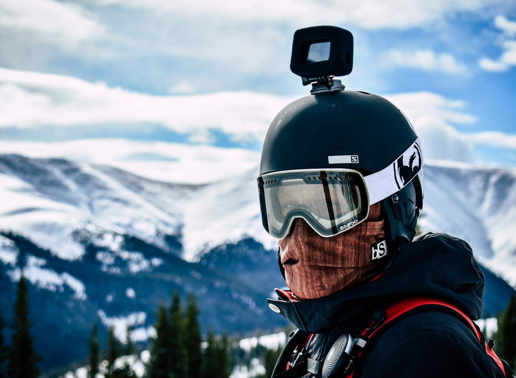 man in goggles and helmet with action camera