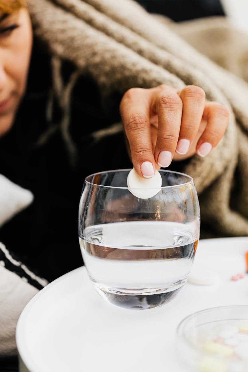 woman put effervescent pill into water