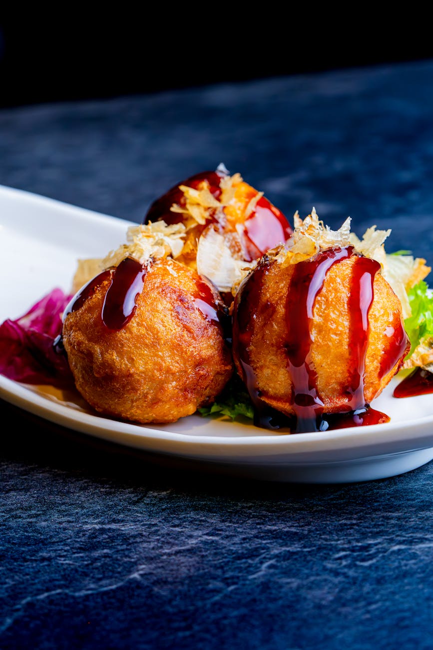 delicious takoyaki in a white dish close up
