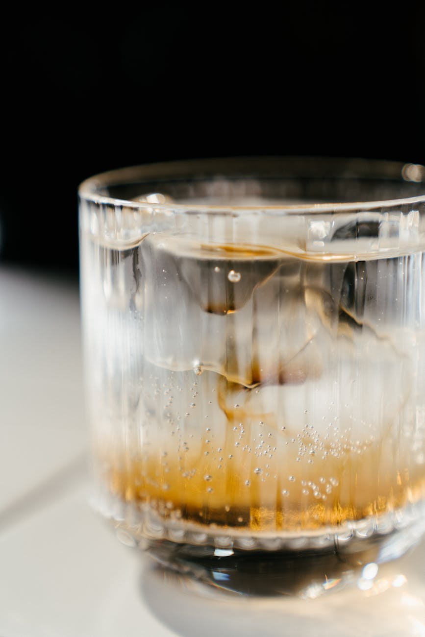 clear drinking glass with brown liquid