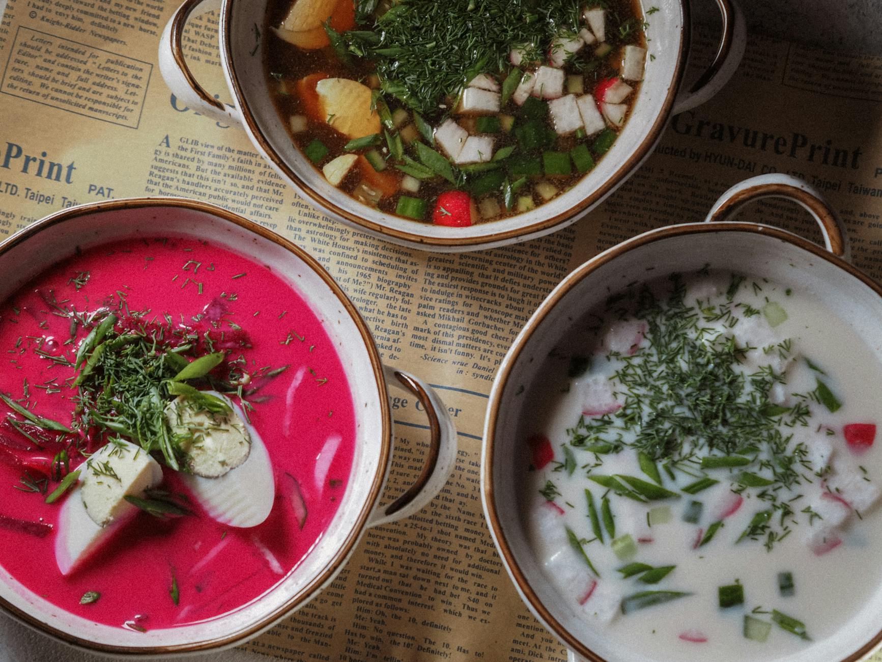 variety of soup dishes in cooking pots