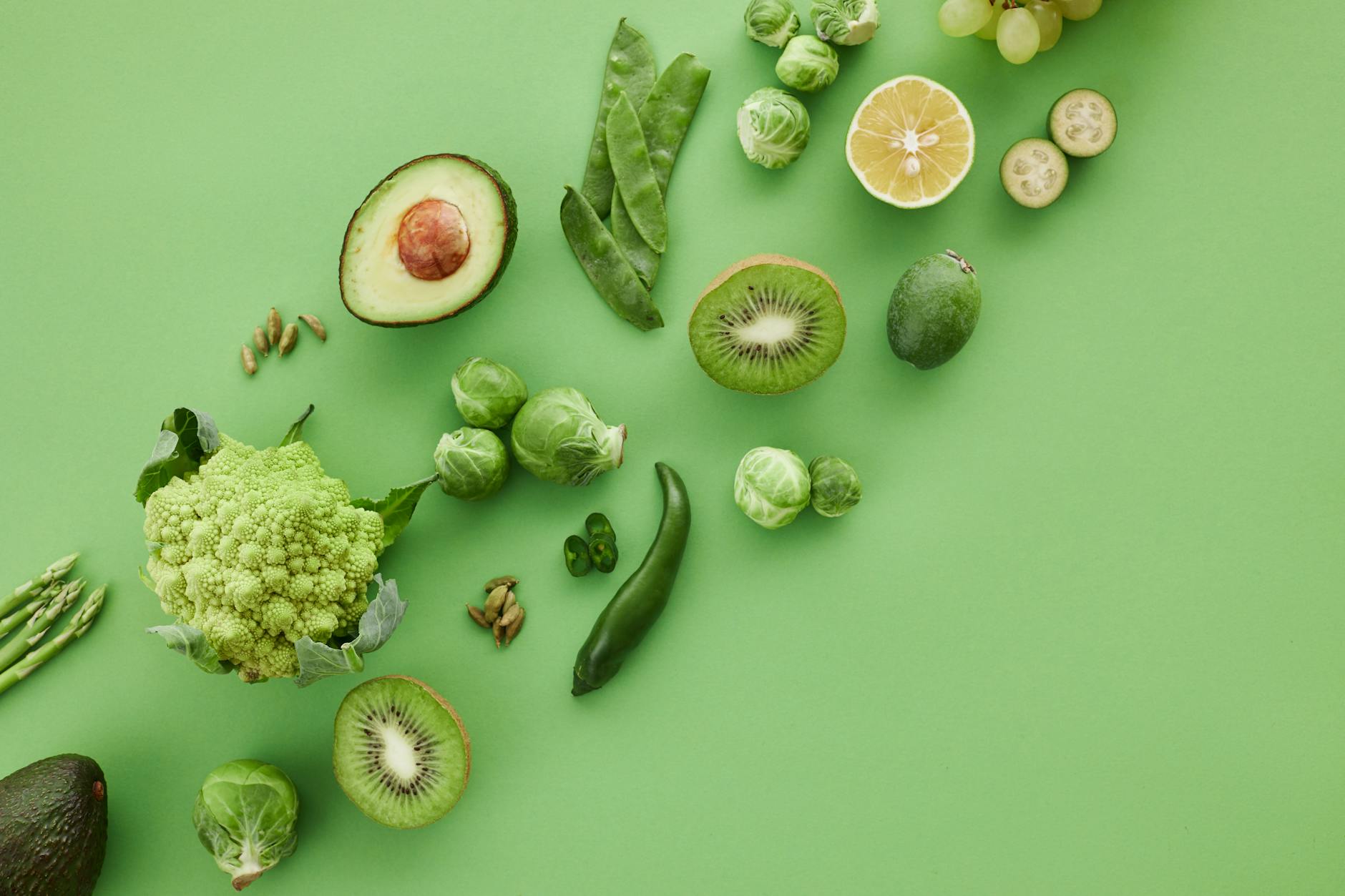 slices of fruits beside green vegetables