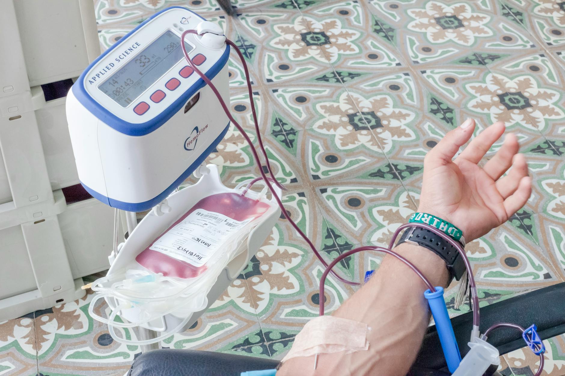a blood collector attached on a person s hand