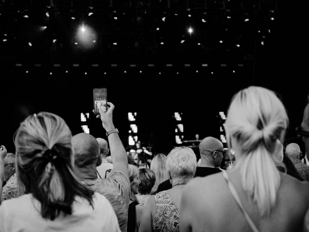 grayscale photo of people gathering in concert