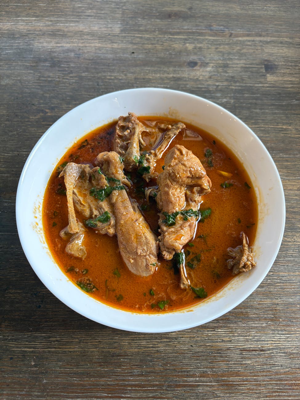 spicy chicken soup in white ceramic bowl