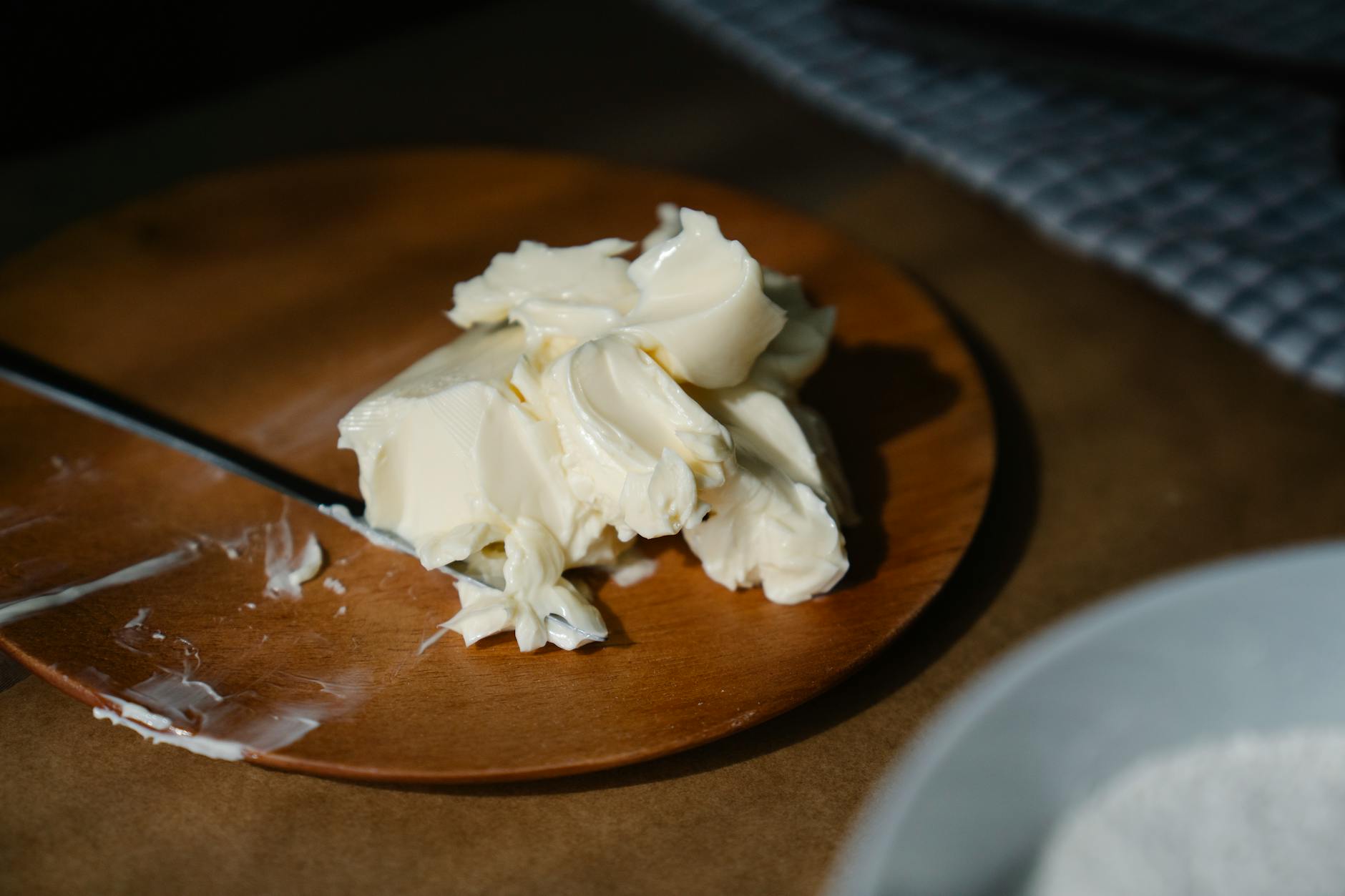 close up shot of a creamy butter on a wooden plate